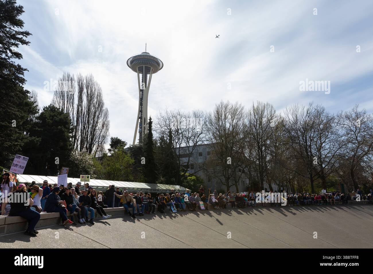 Protesters and supporters gather along the International Fountain at Seattle Center for the “Hands Off!” rally in Seattle on Saturday, April 5, 2025. Stock Photo