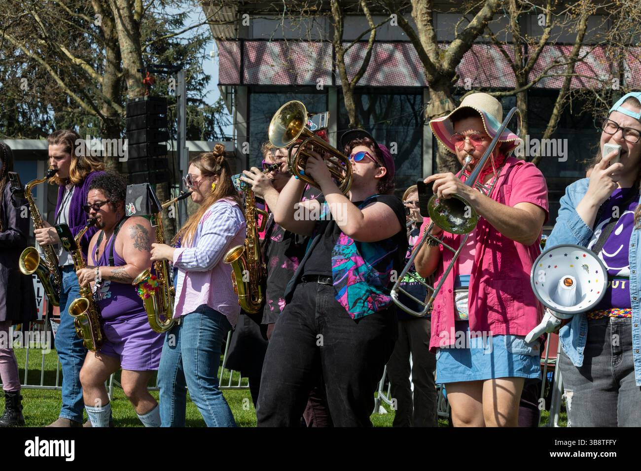 Members of AGAB, a queer brass band, entertain supporters at Seattle Center during the “Hands Off!” rally in Seattle on Saturday, April 5, 2025. The p Stock Photo