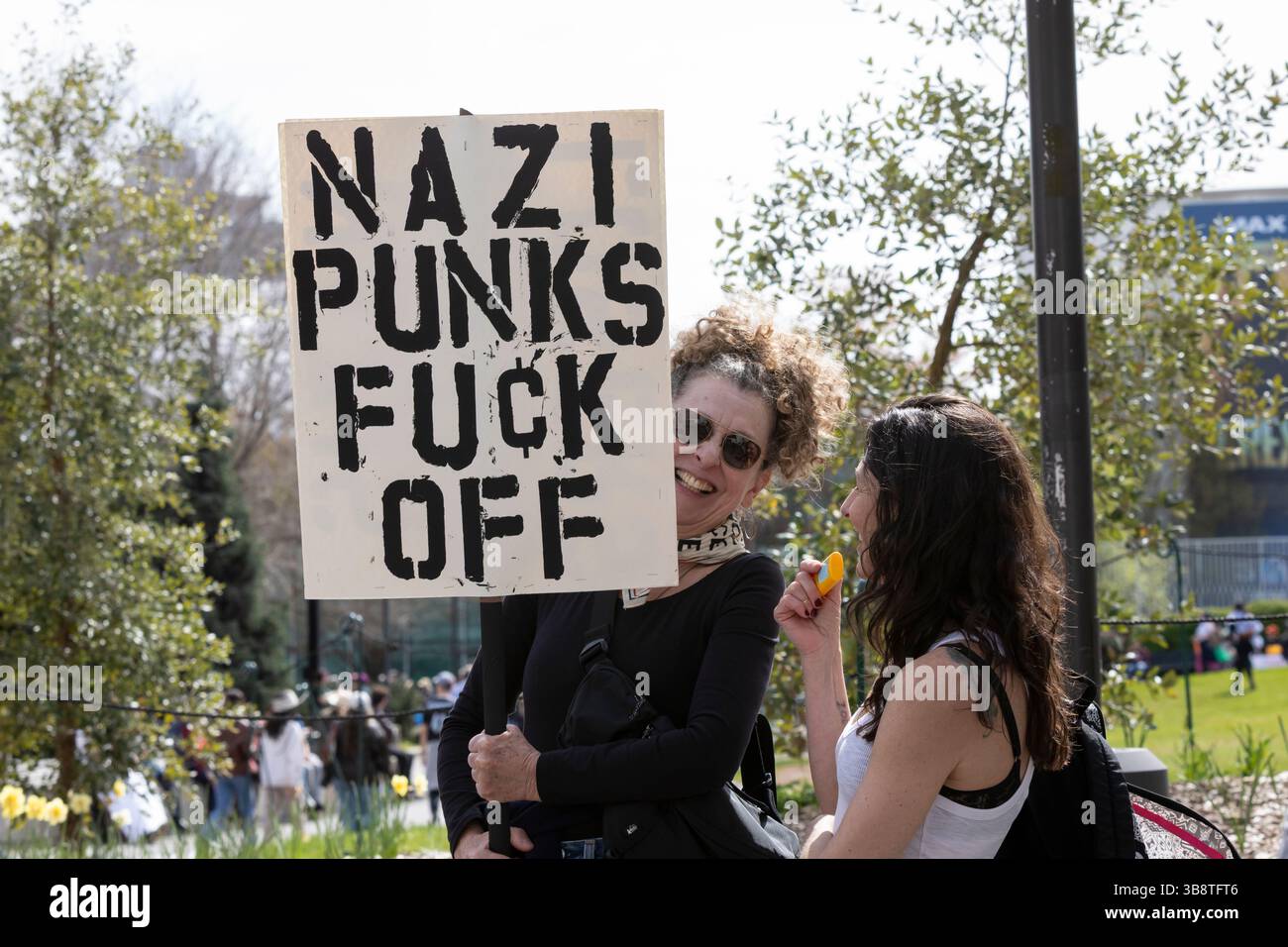 Beatrice Basnight (left) speaks with a friend at Seattle Center during the “Hands Off!” rally in Seattle on Saturday, April 5, 2025. The protest is pa Stock Photo