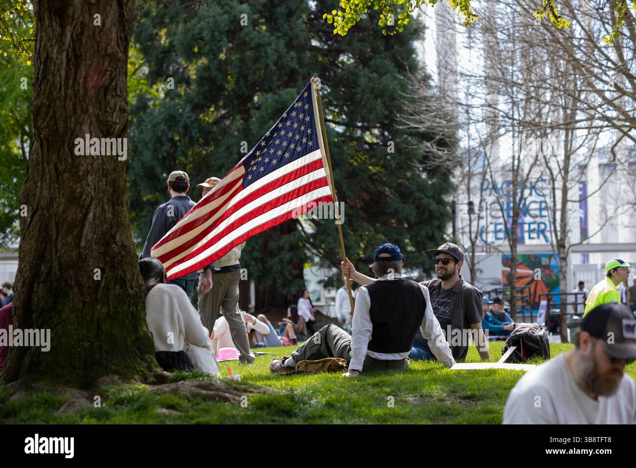 Patriotic protesters take a rest at Mural Amphitheatre during the “Hands Off!” rally at Seattle Center in Seattle on Saturday, April 5, 2025. The prot Stock Photo