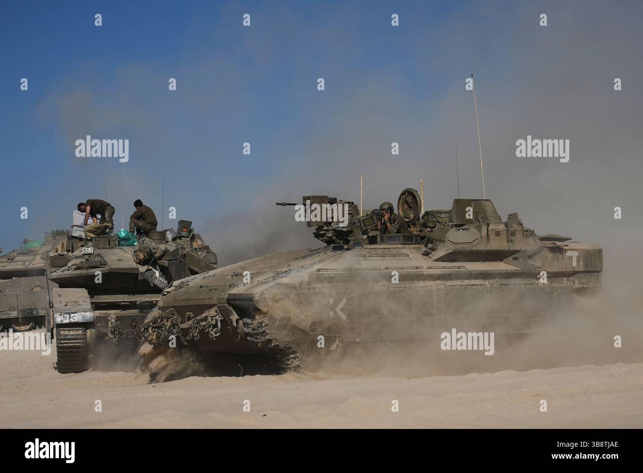 Israeli troops move with APC, armored personnel carrier near the border ...