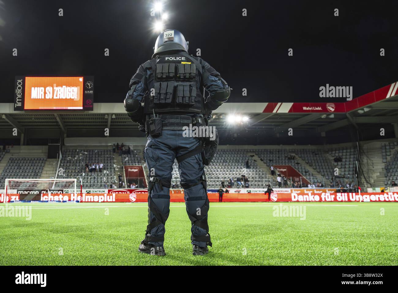 Police officer in combat gear Football stadium Stock Photo