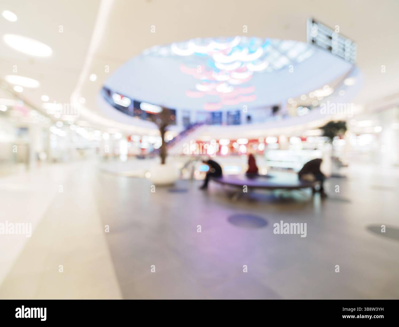 Shopping mall blur background with bokeh. Blurred hall of shopping mall with customers as background. Copy space Stock Photo