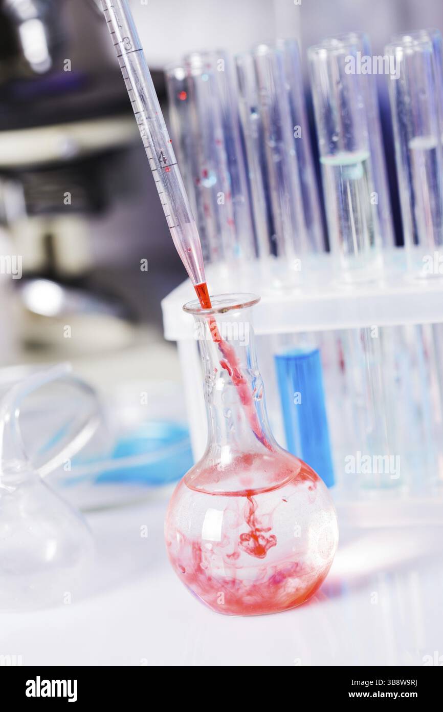 Scientist shows a diffusion in the flask Stock Photo