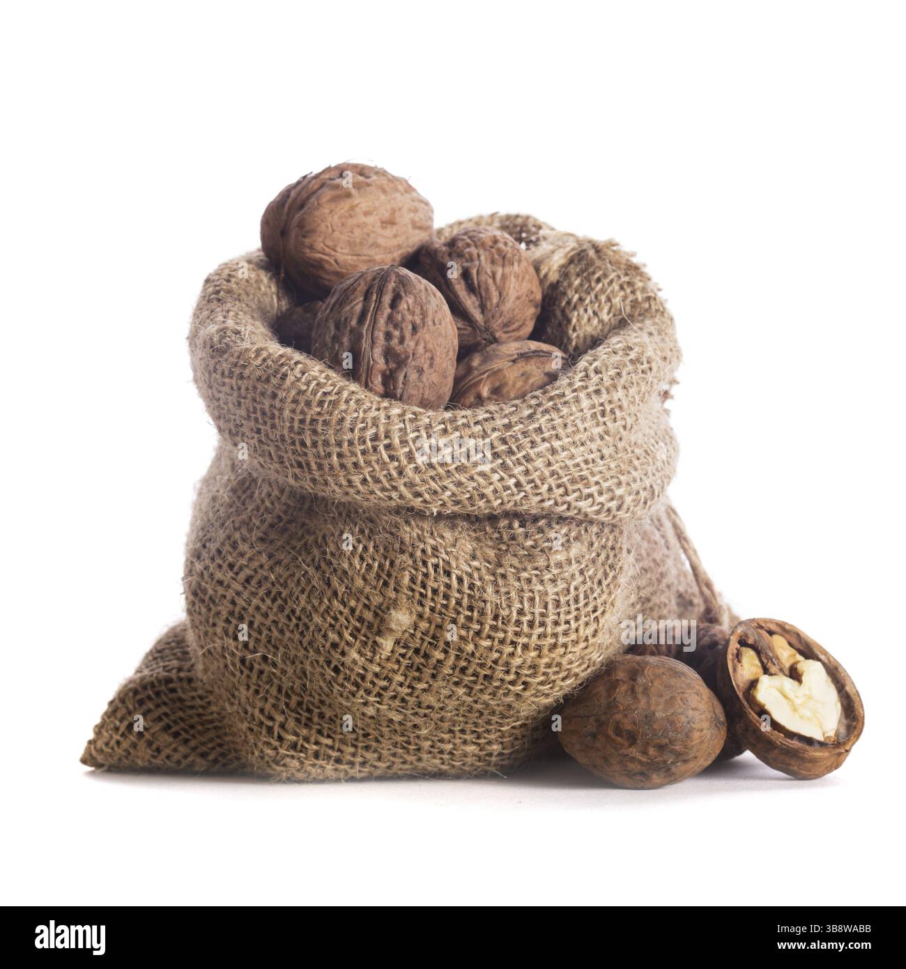 Walnuts in burlap bag isolated on white Stock Photo