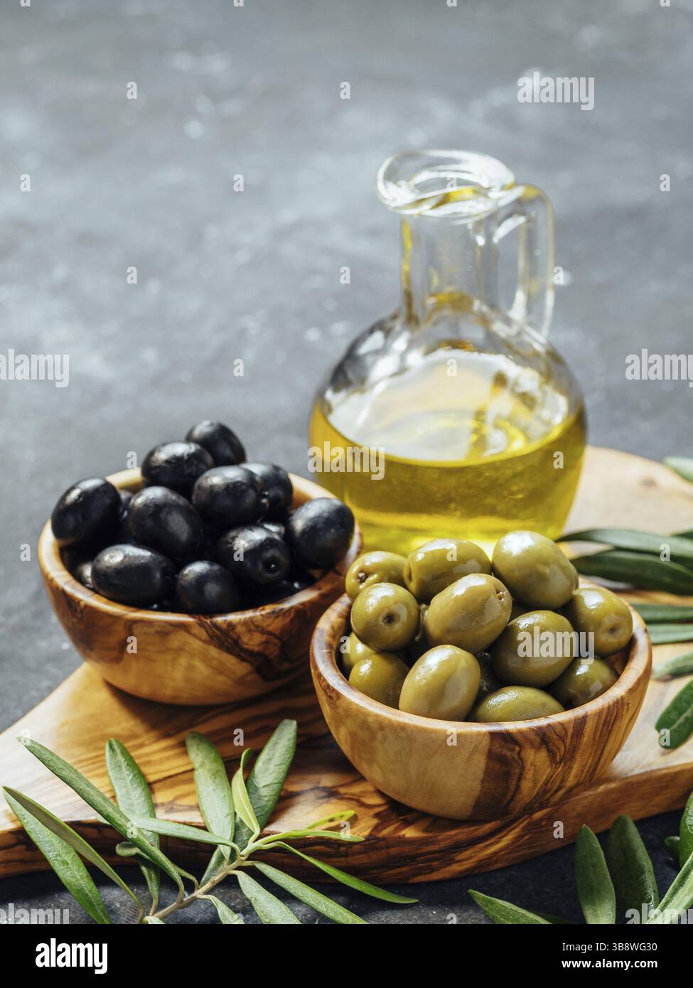 Set of green and black olives and olive oil on gray background ...
