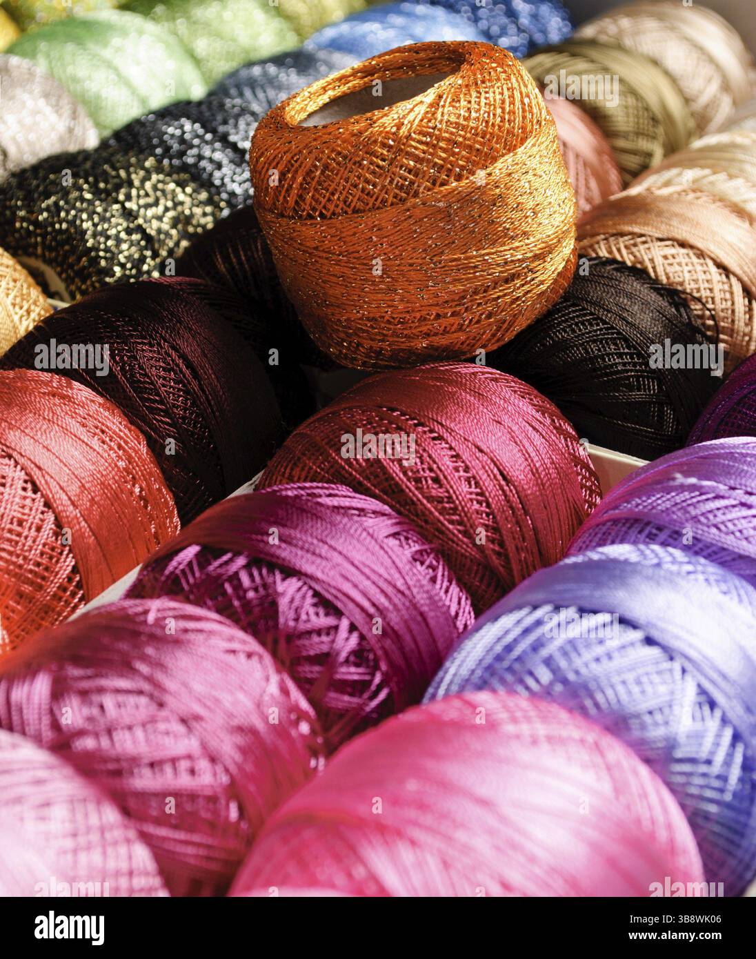 Different color threads on rows in the store Stock Photo - Alamy