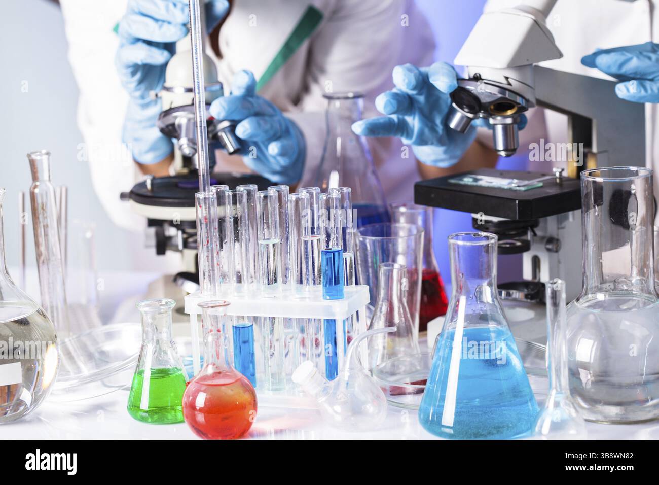 Two scientists in the chemical laboratory are doing experiments Stock Photo