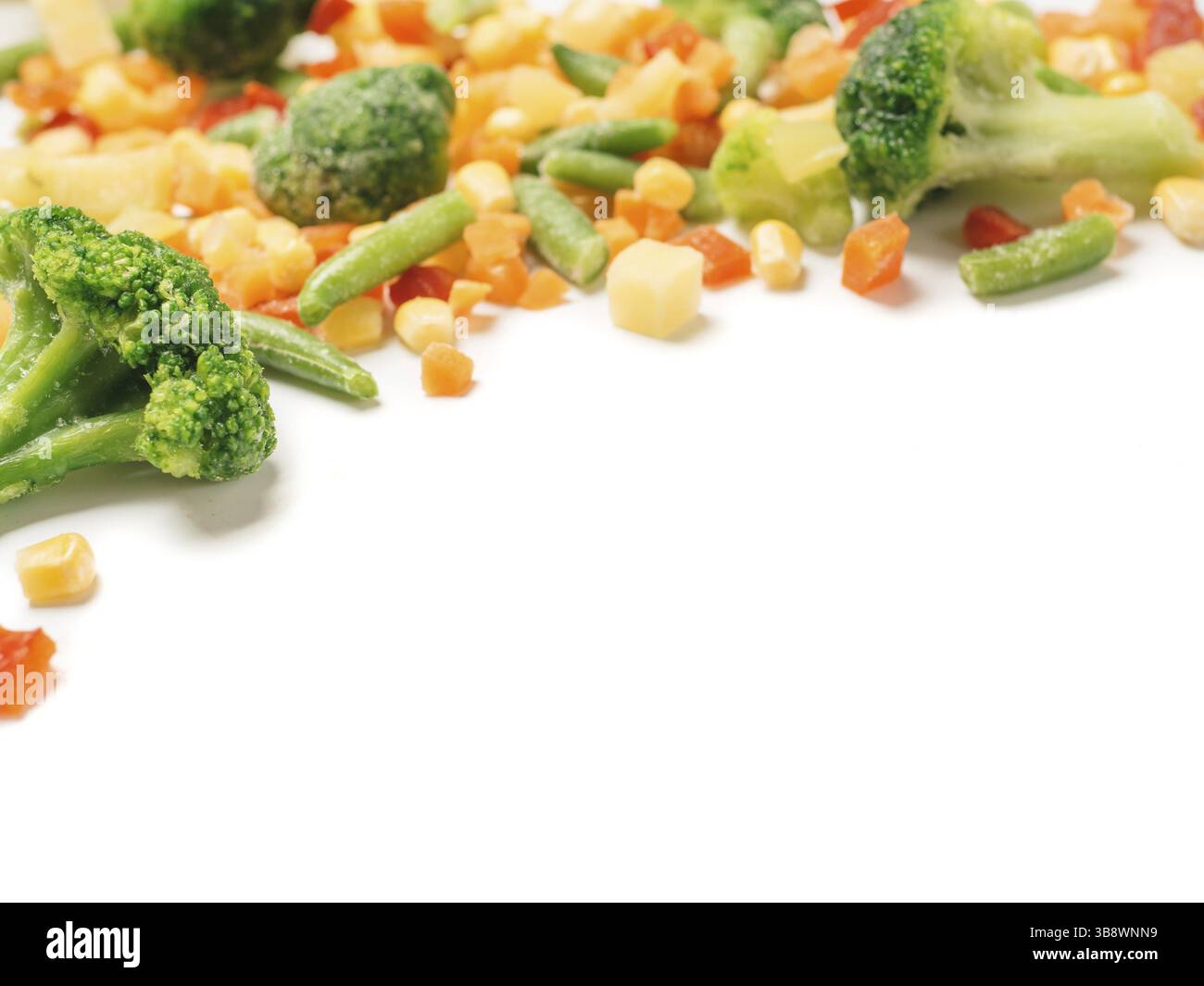 Frozen vegetables assorted isolated on white with clipping path. Frosen vegetables with ice Isolated one edge. Frozen mix vegetables with copy space f Stock Photo
