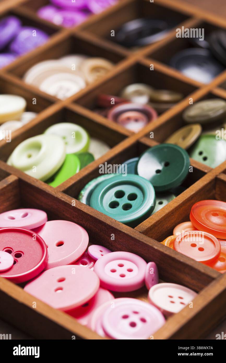Colorful buttons in a wooden box for design Stock Photo - Alamy