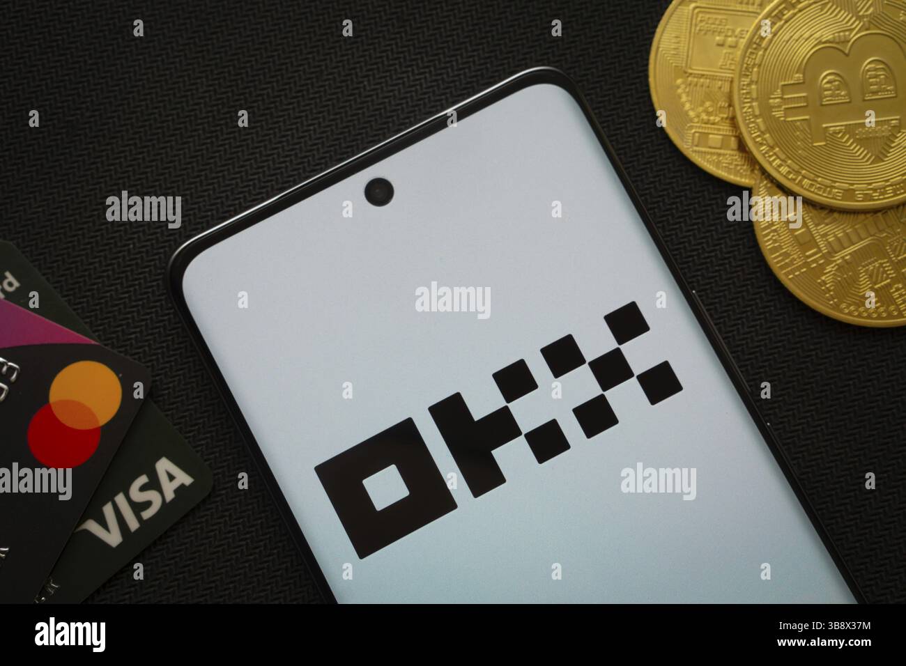 Dhaka, Bangladesh - 04 April 2025: The logo of the OKX is displayed on a smartphone screen. OKX is the second largest cryptocurrency exchange platform Stock Photo