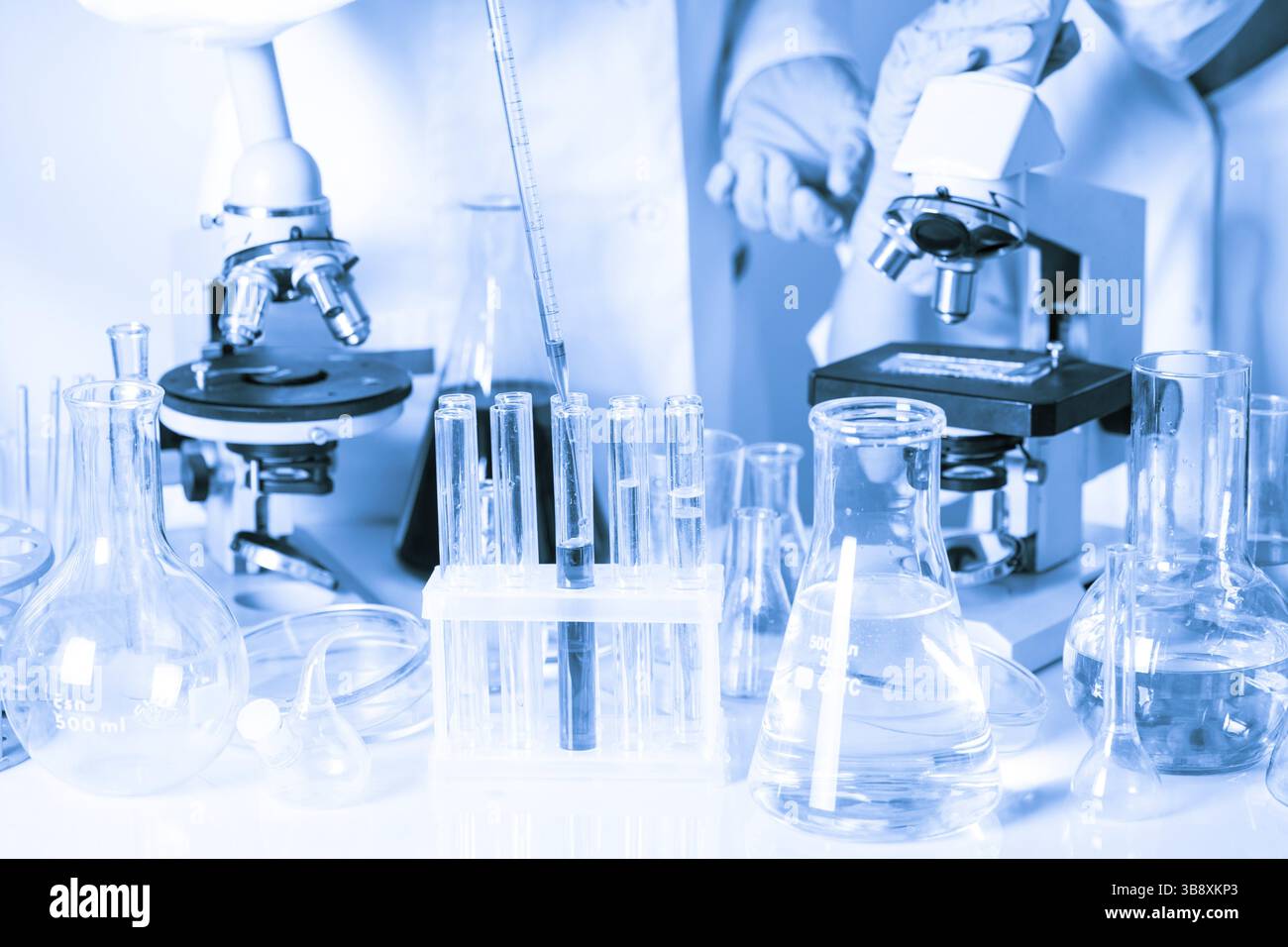 Two scientists in the chemical laboratory are doing experiments Stock Photo