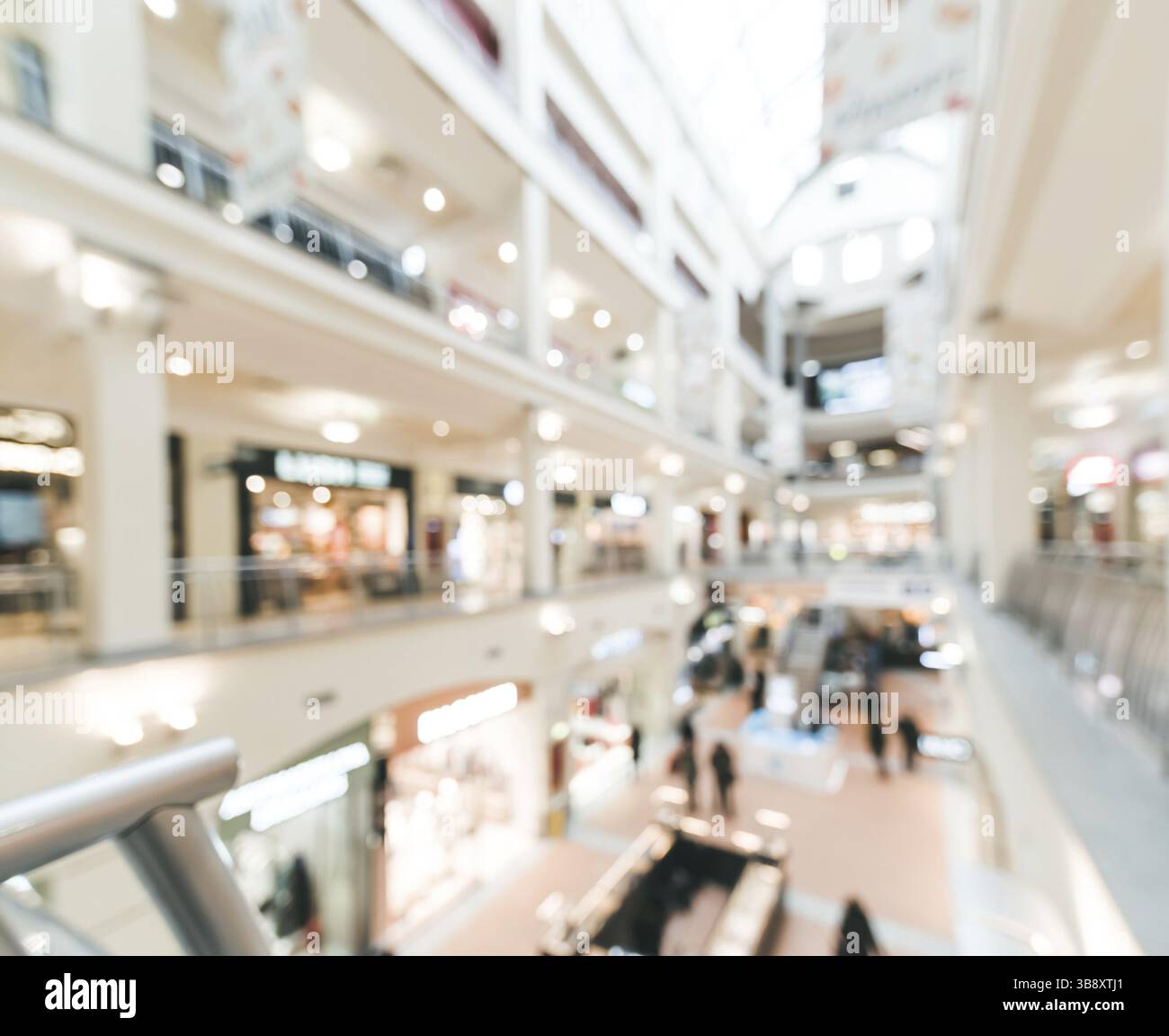 Shopping mall blur background with bokeh. Blurred hall of shopping mall with customers as background. Copy space Stock Photo