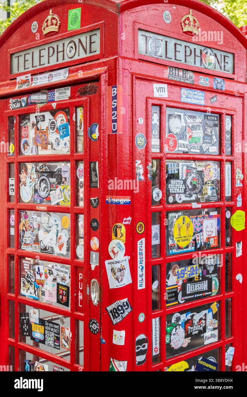 Stickers on the door of a red phone box Stock Photo - Alamy