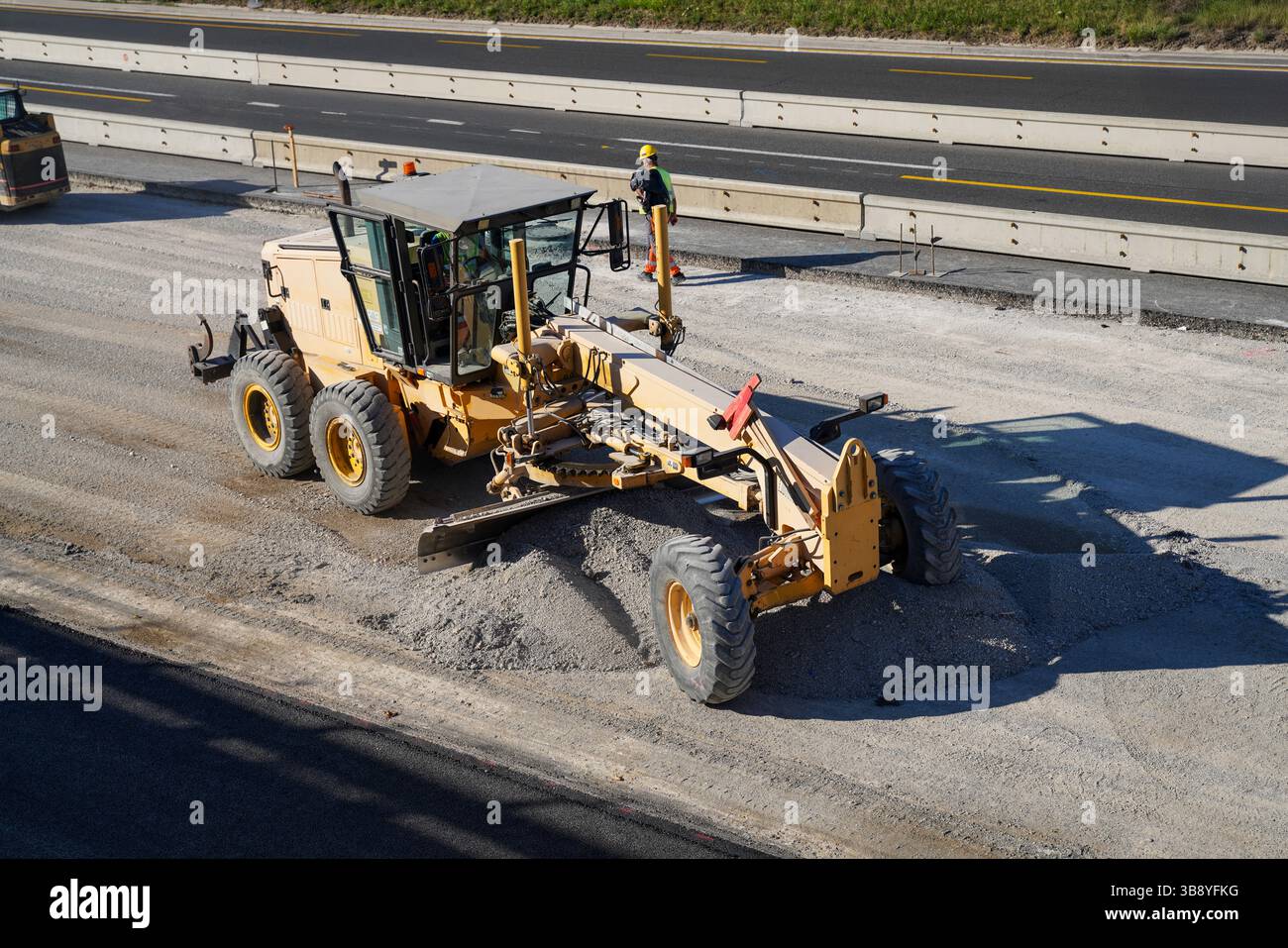 Capturing a motor grader spreading gravel to create a smooth and level