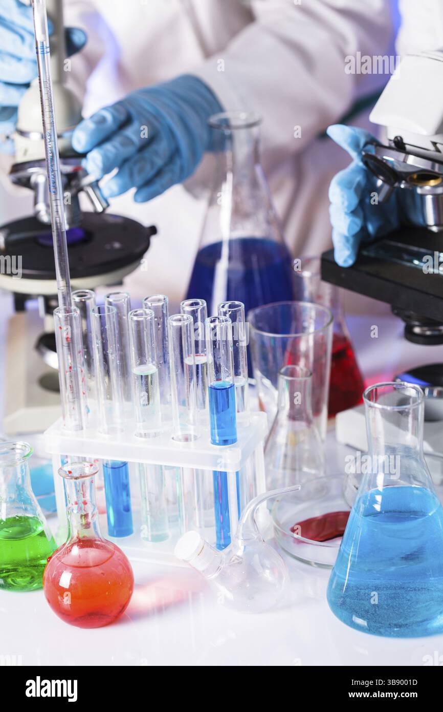 Two scientists in the chemical laboratory are doing experiments Stock Photo