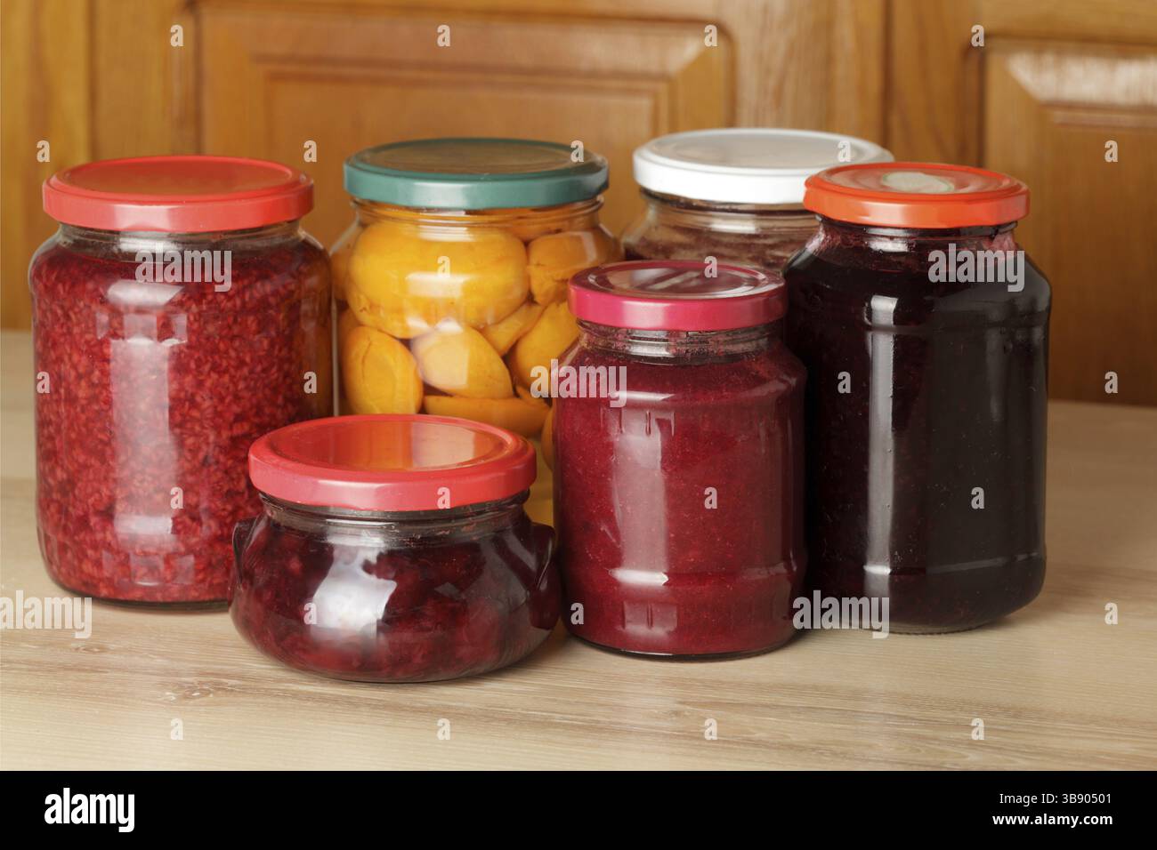 Various jams and compotes on table in kitchen Stock Photo