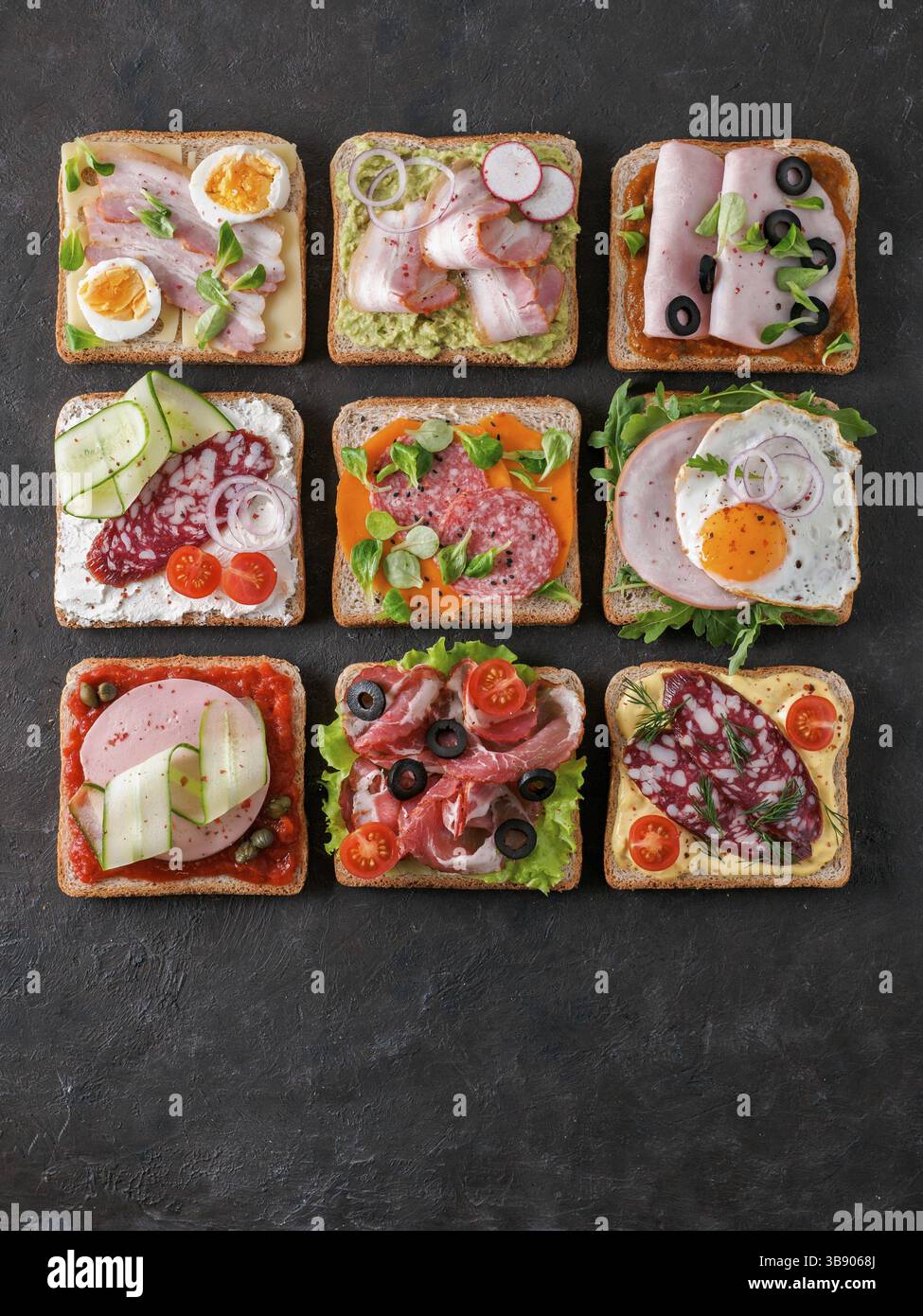 Set of eight different sandwiches with meat in square shape, copy space for text. Top view or flat lay. Assortment meat toasts on black background. Id Stock Photo