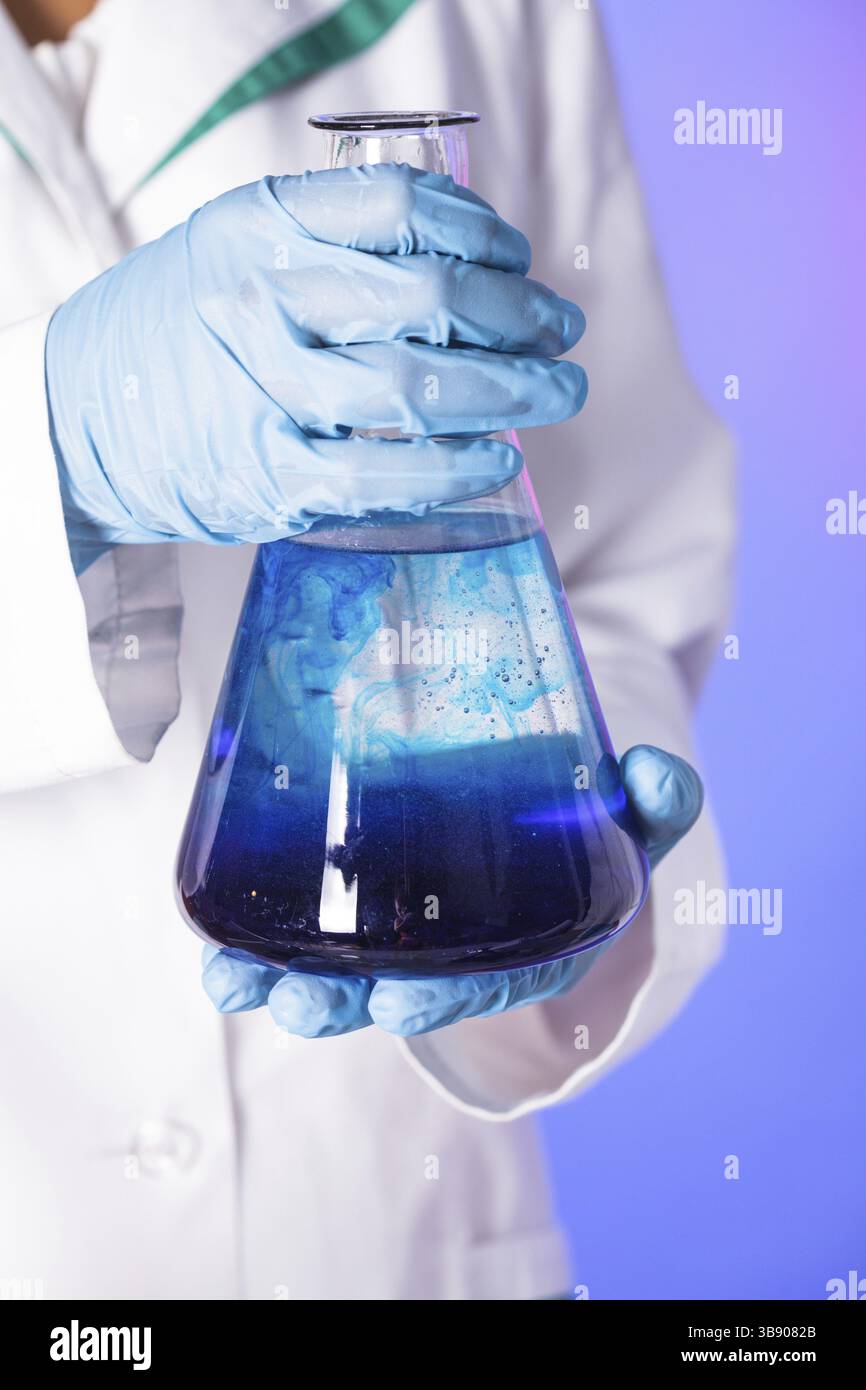 Scientist shows a diffusion in the flask Stock Photo