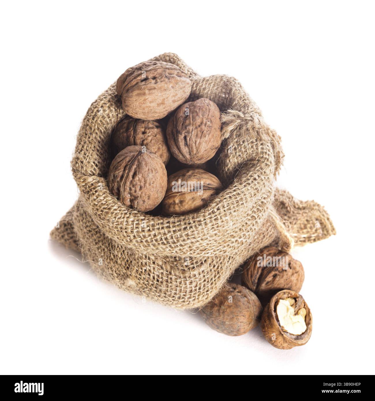 Walnuts in burlap bag isolated on white Stock Photo