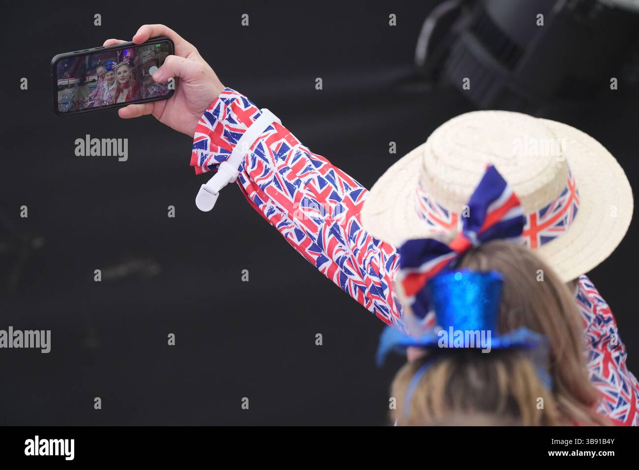 Members of the audience wearing patriotic outfits before the start of the concert celebrating the 80th Anniversary of VE Day, held at the historic Horse Guards Parade in central London. Picture date: Thursday May 8, 2025. Stock Photo
