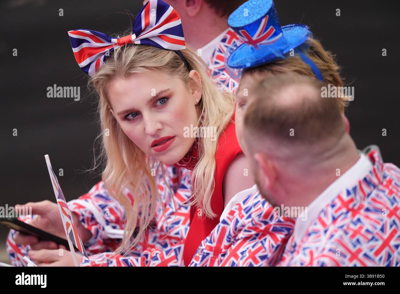 Members of the audience wearing patriotic outfits before the start of the concert celebrating the 80th Anniversary of VE Day, held at the historic Horse Guards Parade in central London. Picture date: Thursday May 8, 2025. Stock Photo