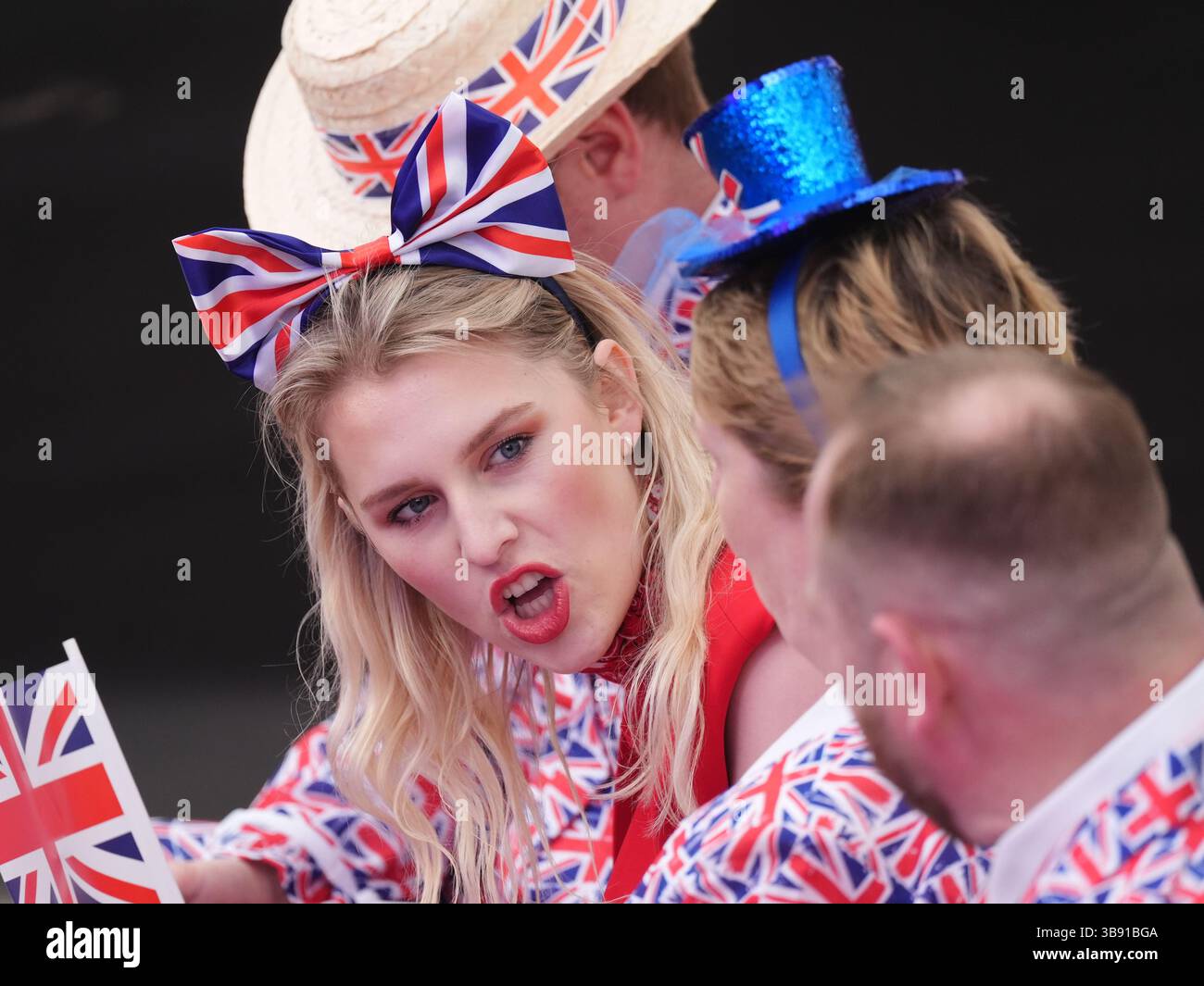 Members of the audience wearing patriotic outfits before the start of the concert celebrating the 80th Anniversary of VE Day, held at the historic Horse Guards Parade in central London. Picture date: Thursday May 8, 2025. Stock Photo
