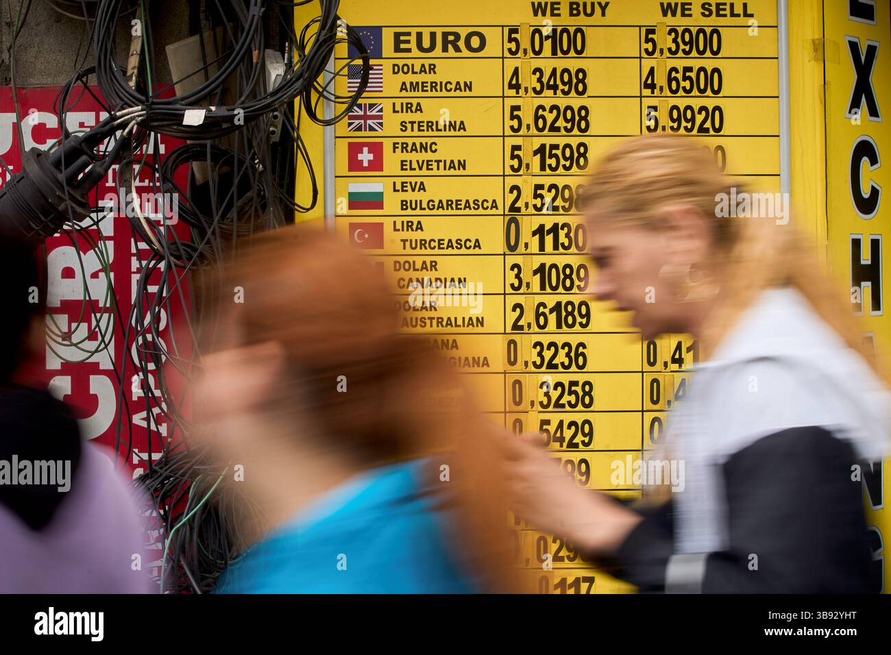 Euro Rising Bucharest, Romania. 8th May, 2025: People walk past a currency exchange ...