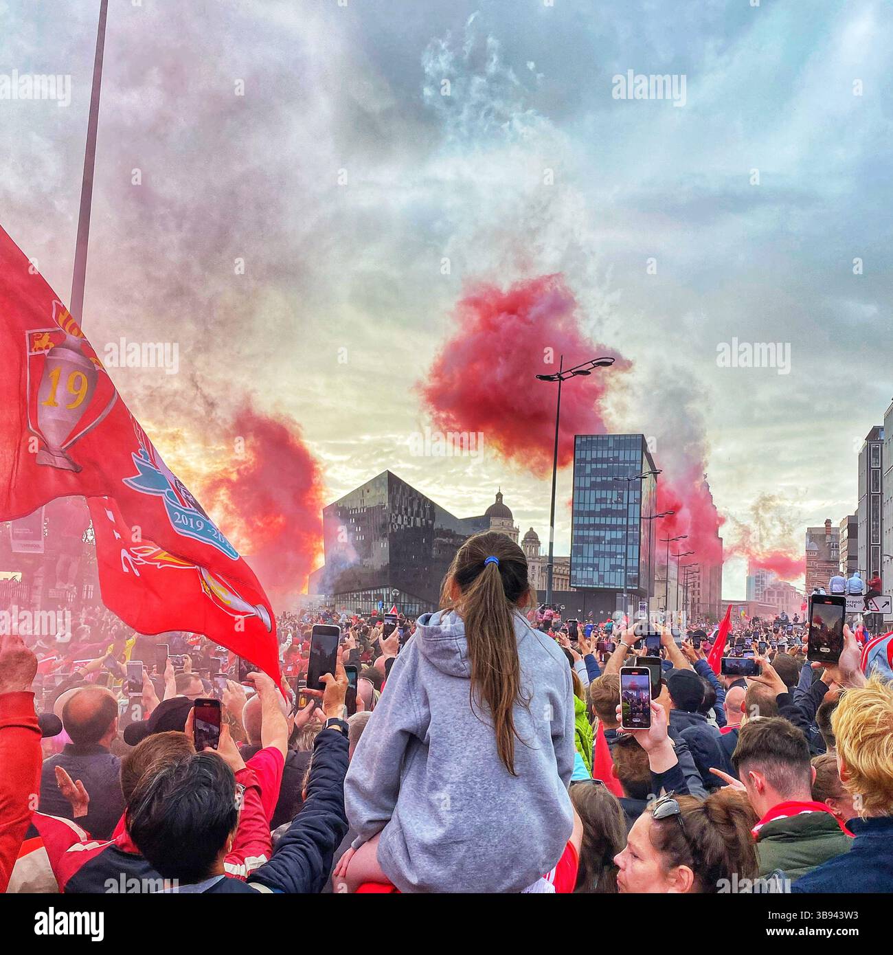 Liverpool FC celebrate FA Cup and Carabao Cup wins with open-top bus parade through Liverpool on 29 May 2022, cheered by thousands of fans. - Smartphone Captured Stock Image