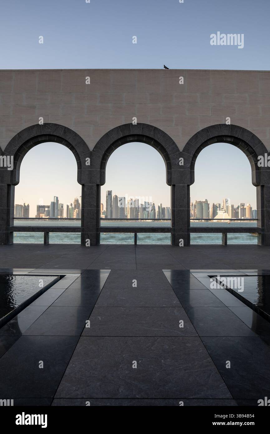 Arches overlooking the city Doha, Qatar. Breathtaking views of the Doha skyline and the Persian Gulf. Stock Photo