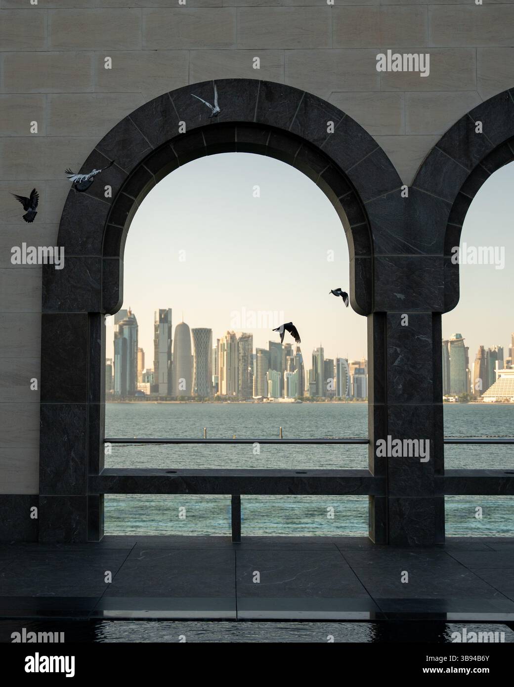 Arches overlooking the city Doha, Qatar. Breathtaking views of the Doha skyline and the Persian Gulf. Stock Photo