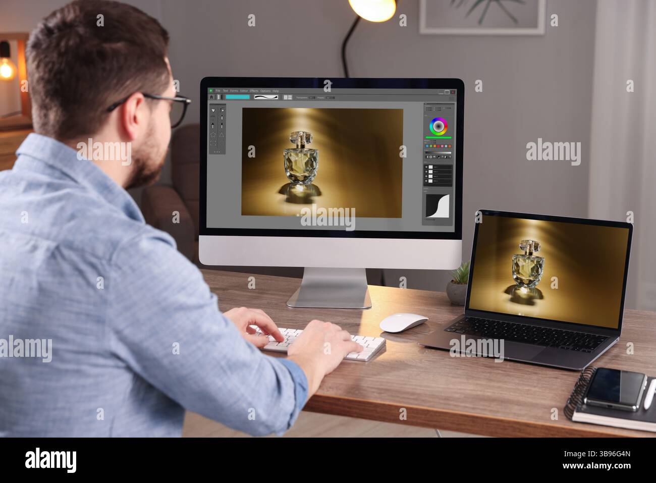 Designer working on different computers at table in office Stock Photo