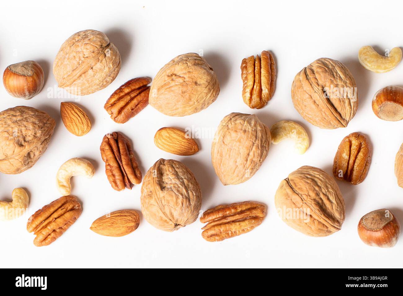Pattern of nuts on a white background. Top view. Panorama. Stock Photo