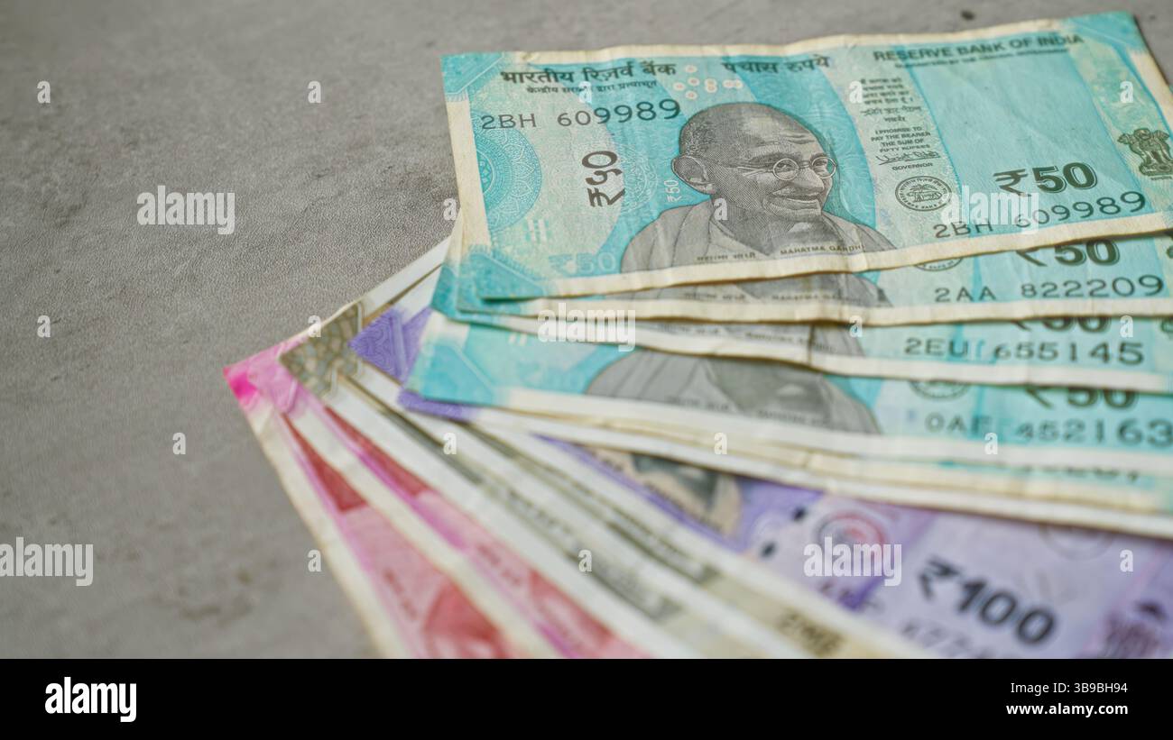 Rupee Color Indian rupee banknotes spread out on a concrete surface showcasing ...