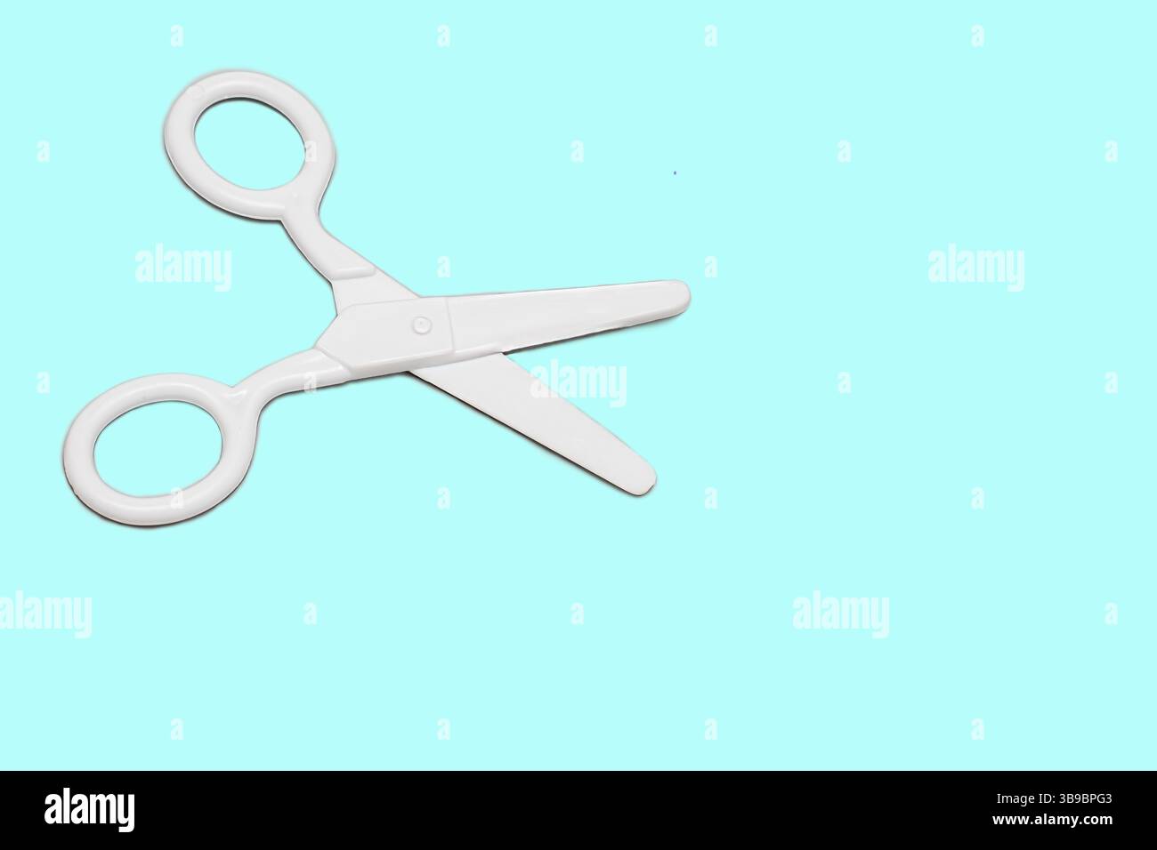 Objects Like Scissors White plastic scissors on a blue background. Isolated object Stock ...