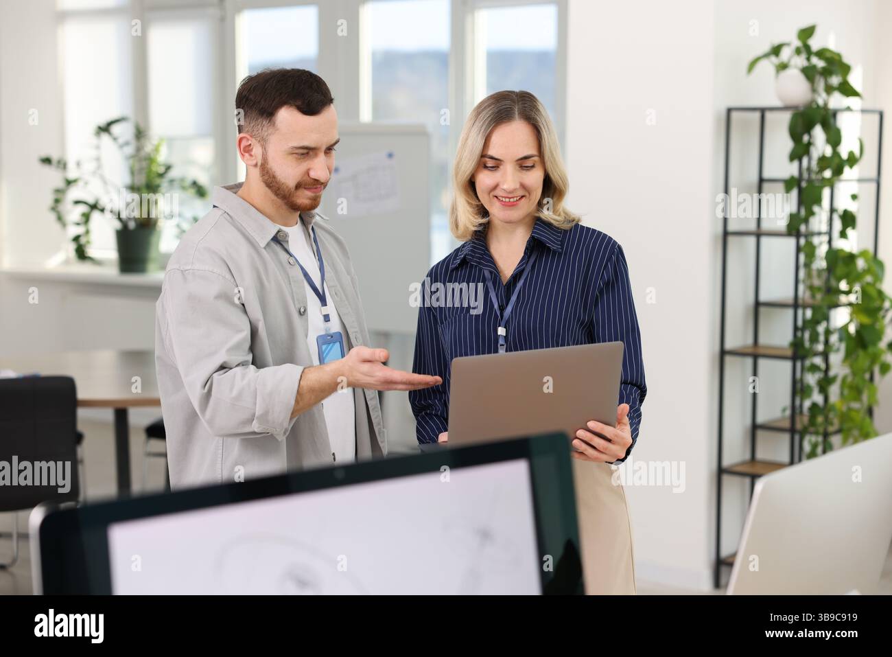 Engineers working together with laptop in office Stock Photo
