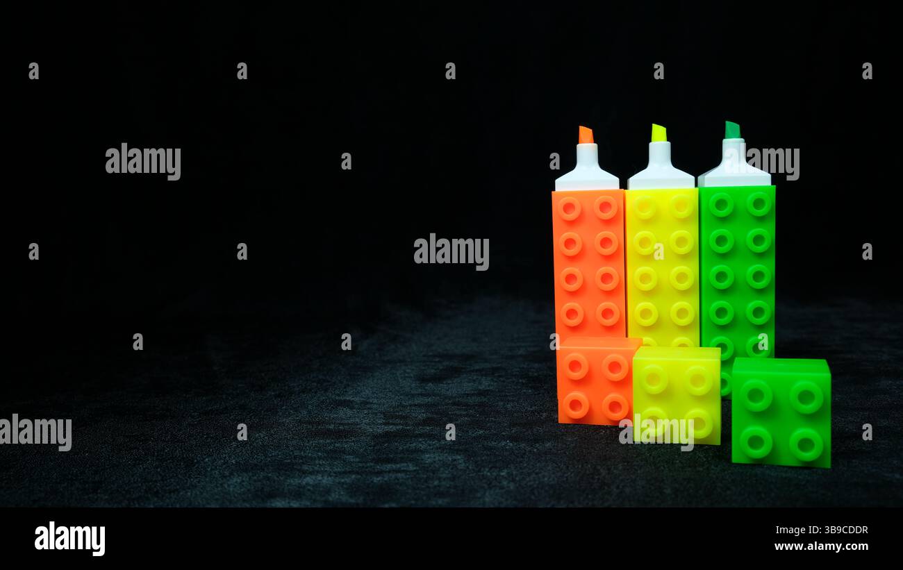 Colorful stationery set: neon markers with Lego-inspired design Stock Photo
