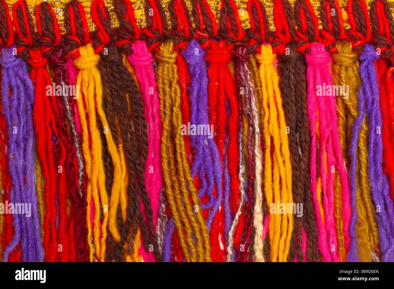 Knotted colored woolen threads in a close up view Stock Photo