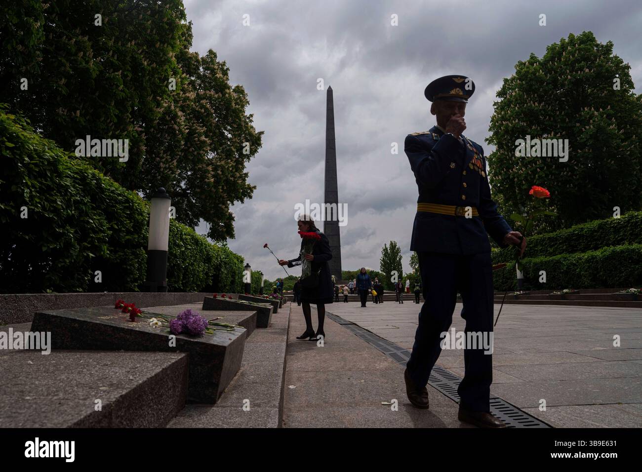 People put flowers at a memorial to World War II veterans during a ...