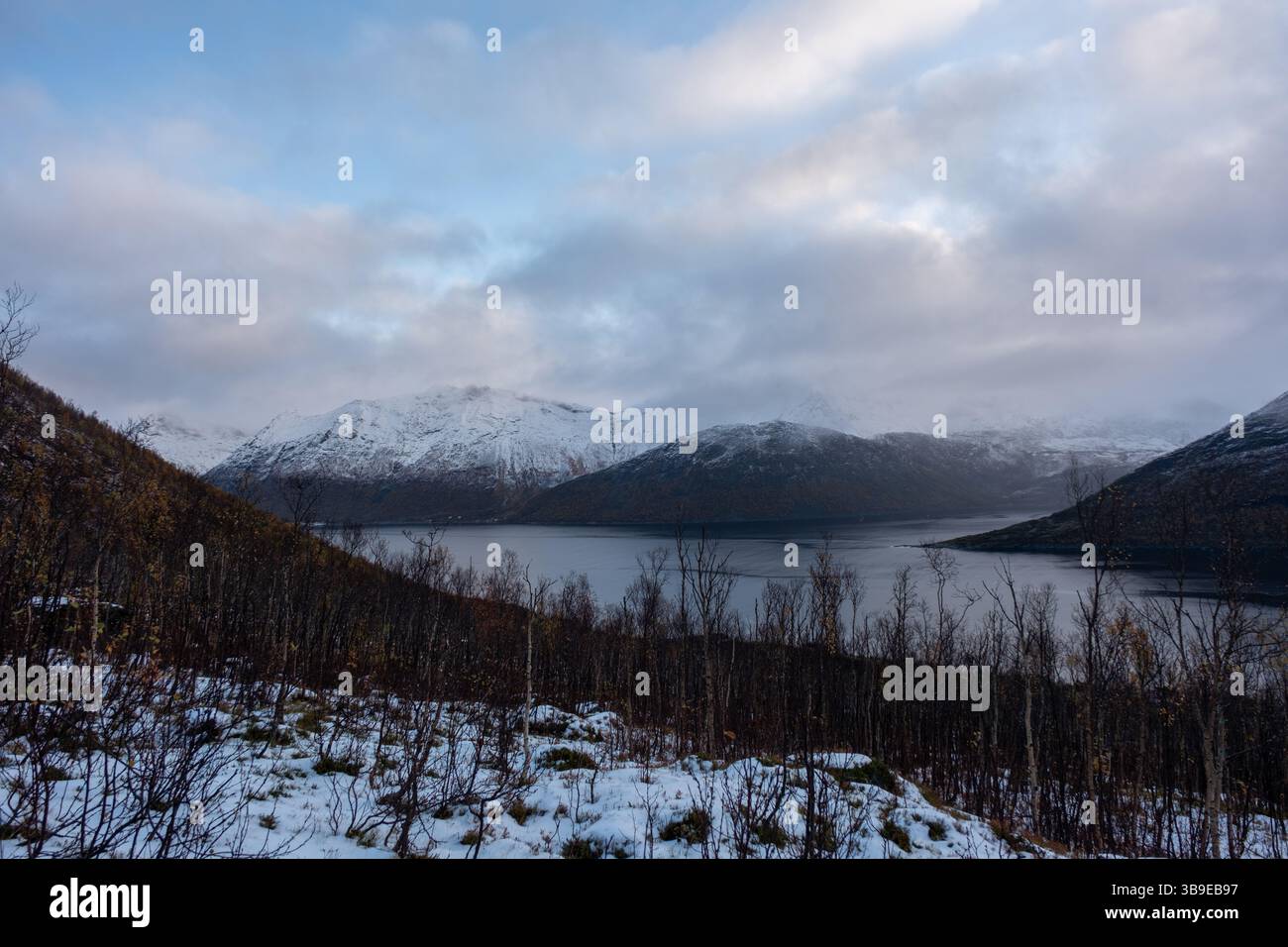 Snowy mountain hike up Segla in Senja, Norway. Snowcapped mountains in the Arctic Circle of Northern Norway Stock Photo