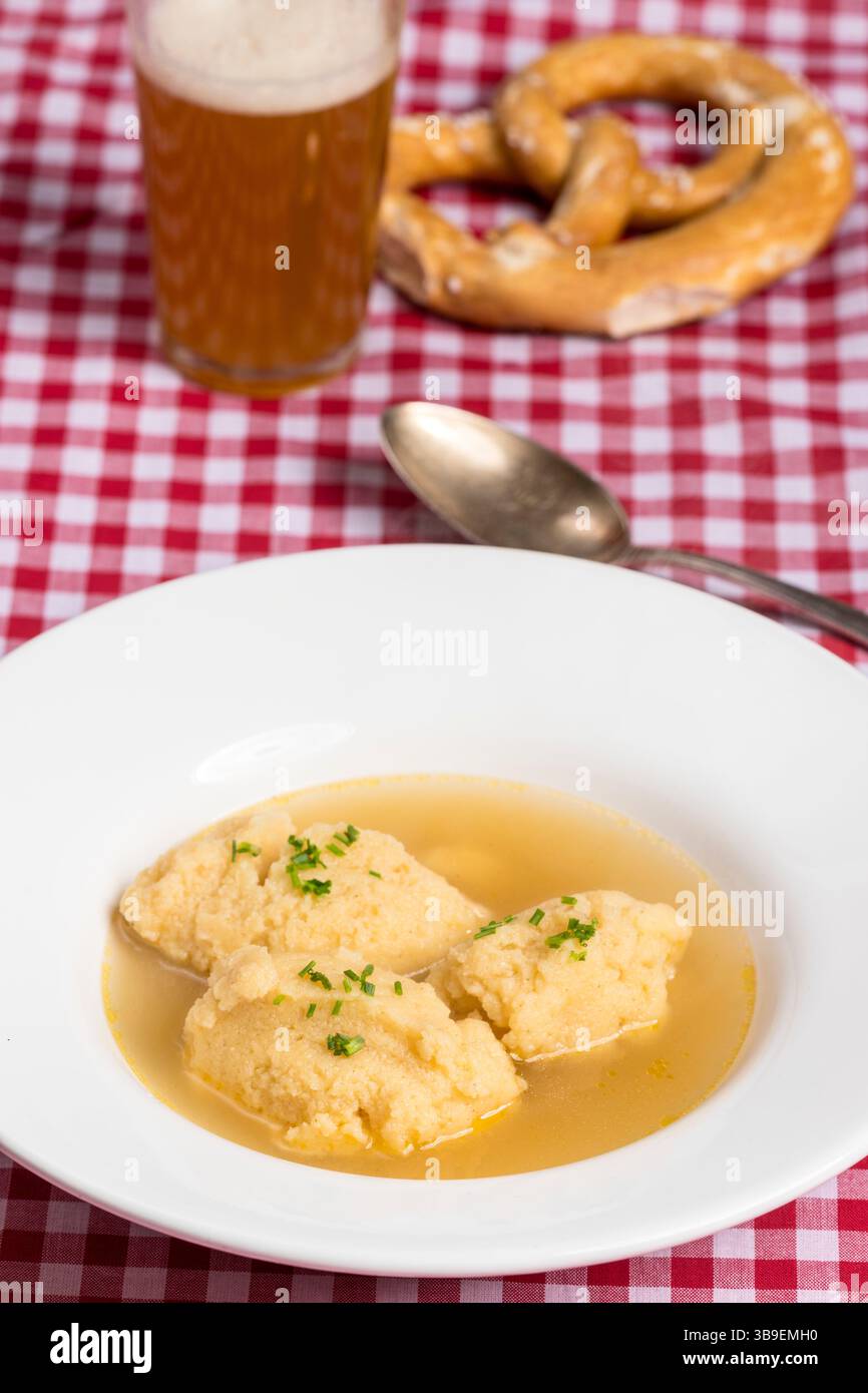 Bavarian dumpling soup on tablecloth Stock Photo