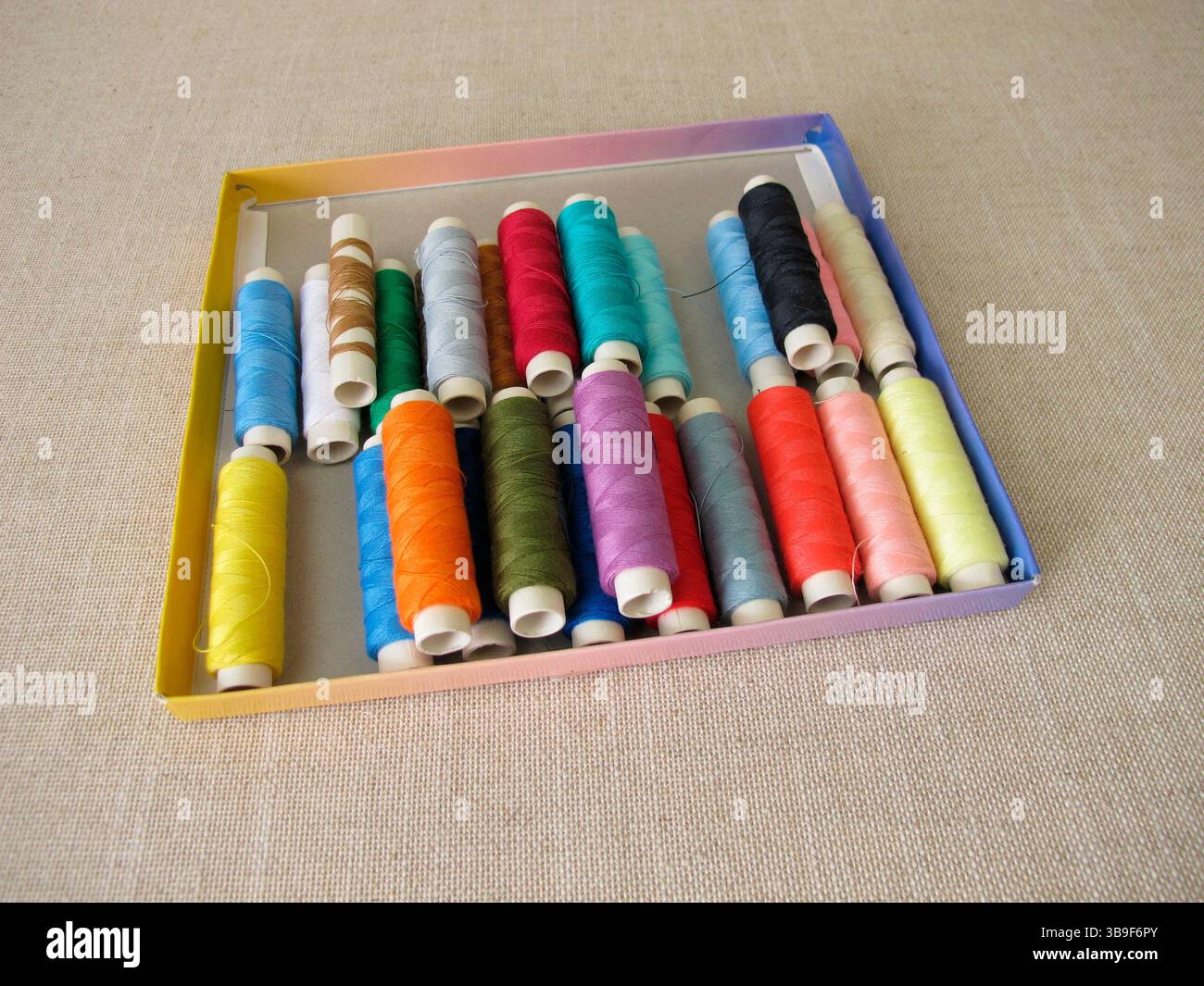 Sewing thread in different colours in a box Stock Photo