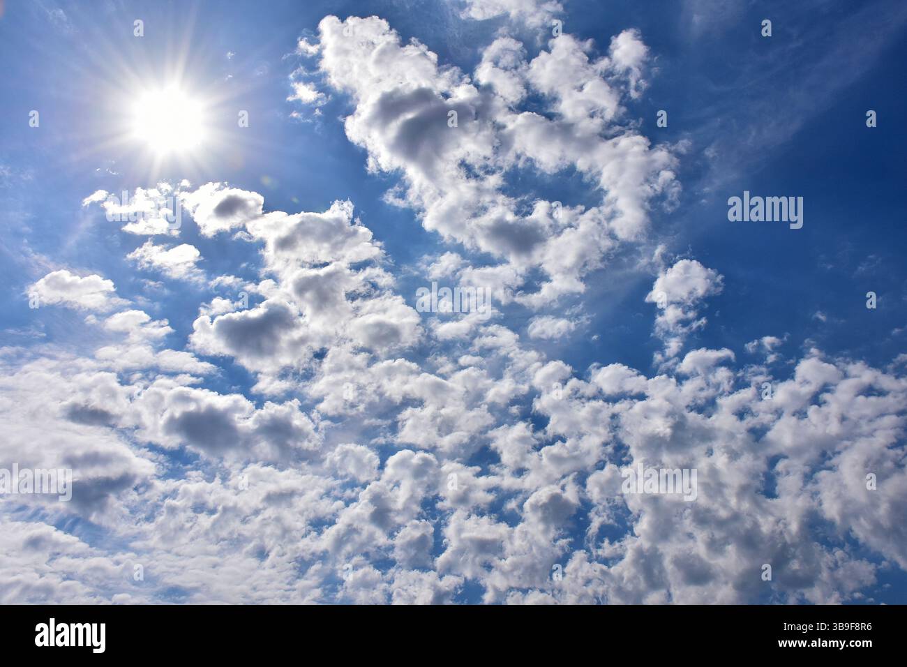 Bright sun between the clouds Stock Photo