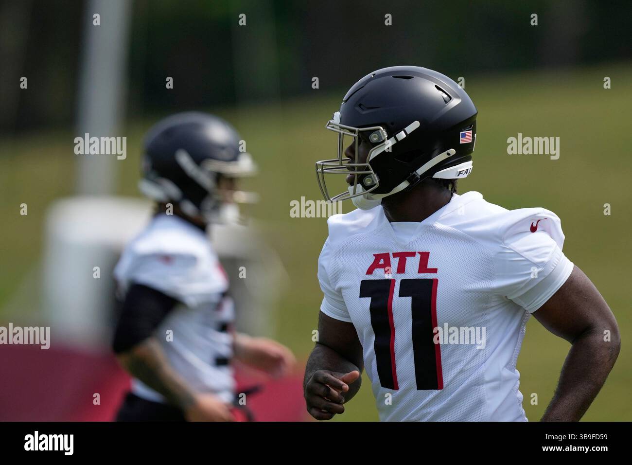 Atlanta Falcons edge rusher Jalon Walker (11) runs drills during the ...