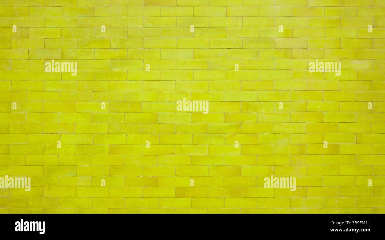 Yellow brick wall with stones - brick wall as background Stock Photo