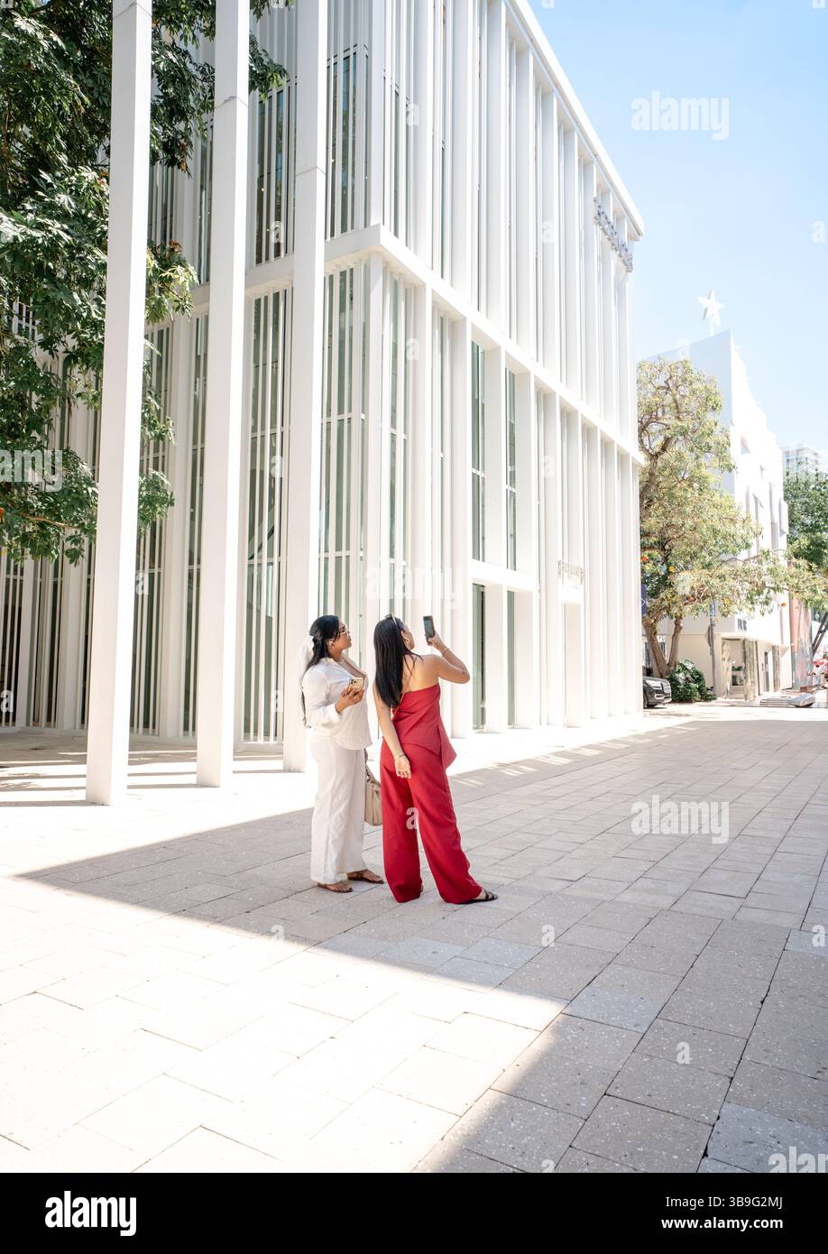 Stylish Women Taking Photos in Miami Design District Stock Photo - Alamy