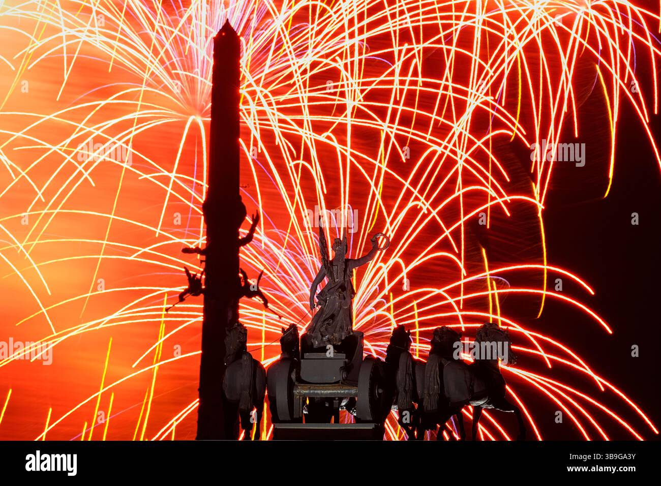 Fireworks explode over Quadriga on the Arc de Triumph and the Victory ...