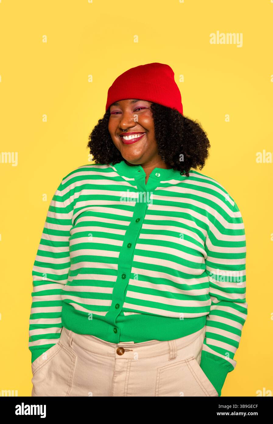 Woman wearing yellow beanie sweater hi-res stock photography and images ...