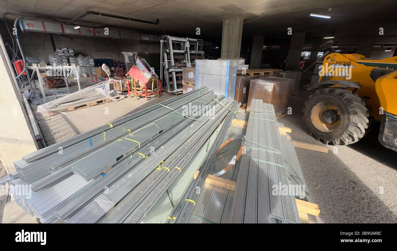 A construction site interior with stacked metal framing, building ...