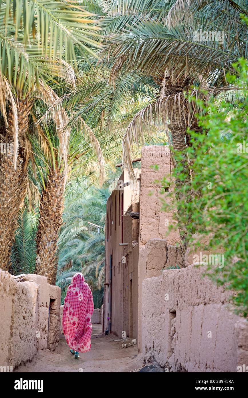 Villager in an alley in the palm grove of Zagora, Draa River valley ...